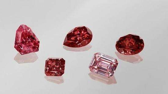 Collection of five hero red gemstones including ruby, red coral, spinel, rubellite tourmaline, and red diamond
