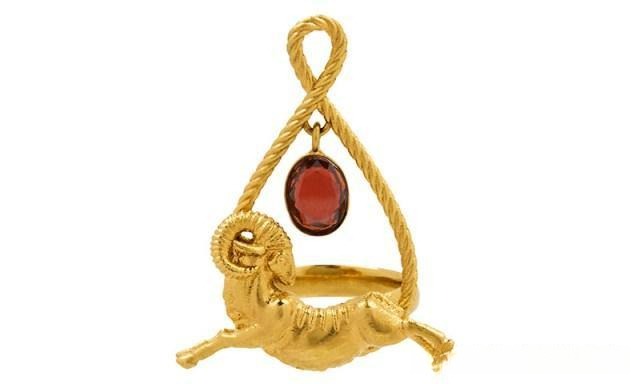 Givenchy ZODIAC Aries pendant featuring a red garnet set in a gold ram design, reflecting the fiery and bold spirit of Aries