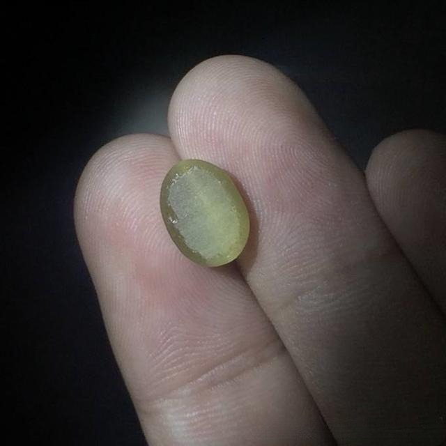 Glass imitation cat’s eye gemstone with perfectly flat and symmetrical base, machine-like appearance