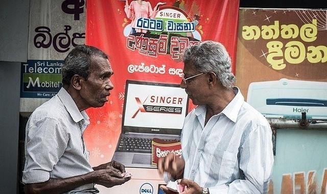 A buyer and a Sri Lankan gem dealer negotiating the final price, illustrating the essential haggling process for Ceylon Sapphire in the market.