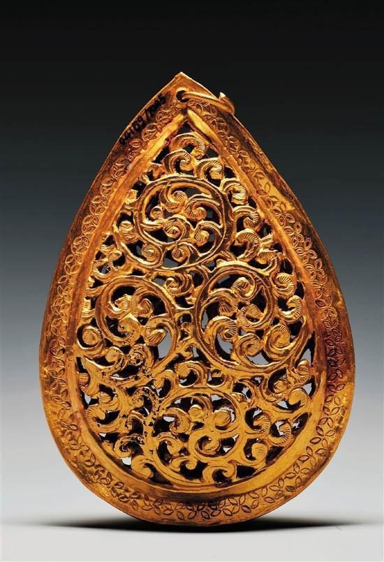 Hand-engraved gold pendant with intricate patterns carved by skilled artisans, showcasing traditional Chinese craftsmanship