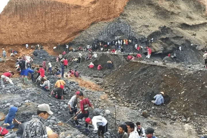 Jadeite mining site showing the pit where raw jadeite boulders are excavated at the origin.