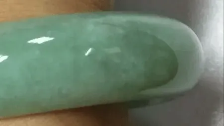 Jewea jadeite bangle with visible Cui Xing flywing texture, typical of coarse-grained jadeite