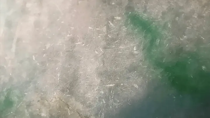 Close-up of Jewea jadeite bangle showing Cui Xing, bright reflective spots near stone flower areas