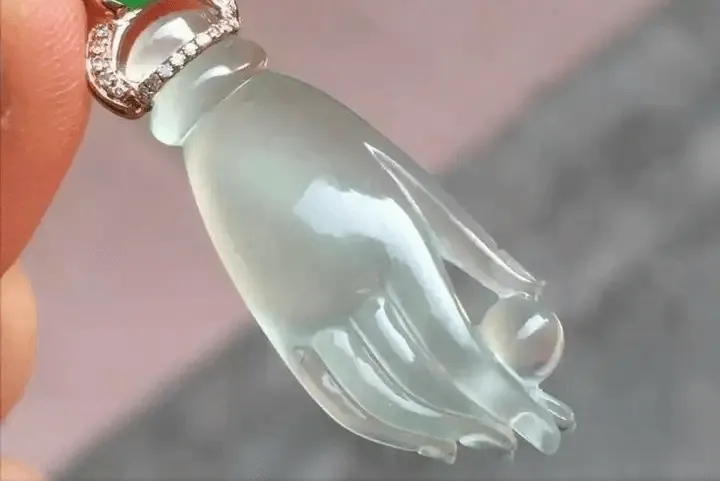 Gel-like jadeite Buddha hand pendant from Jewea with smooth, translucent, jelly-like appearance