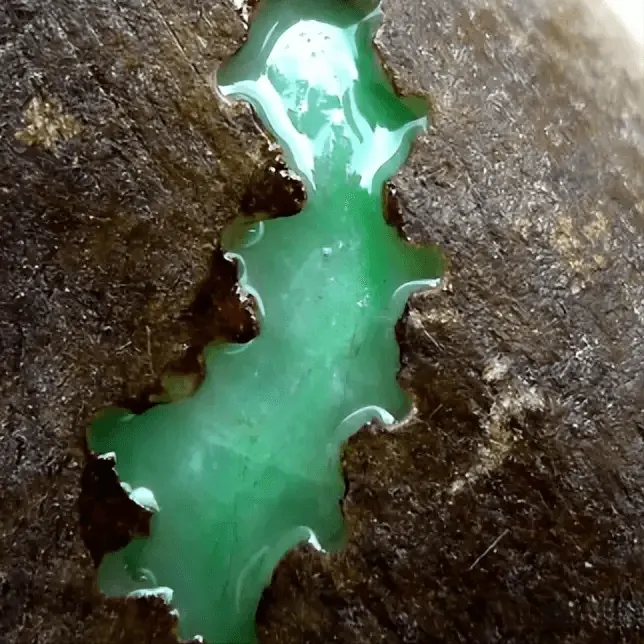 Jadeite rough with a small window cut to reveal internal color and translucency for better evaluation – Jadeite Buying Guide