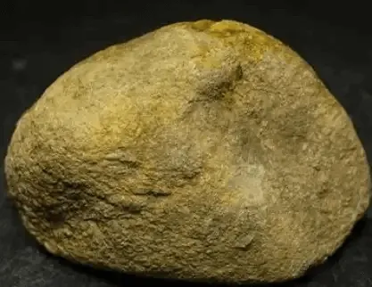 Jadeite rough with coarse sandy skin, textured with visible granules. Variants include white, yellow, iron, and black sandy skins – Jadeite Buying Guide