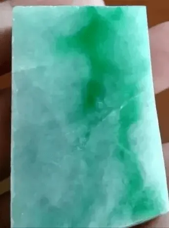 Square jadeite rough stone showing color source, deep green area with concentrated hues, see Jadeite Buying Guide.