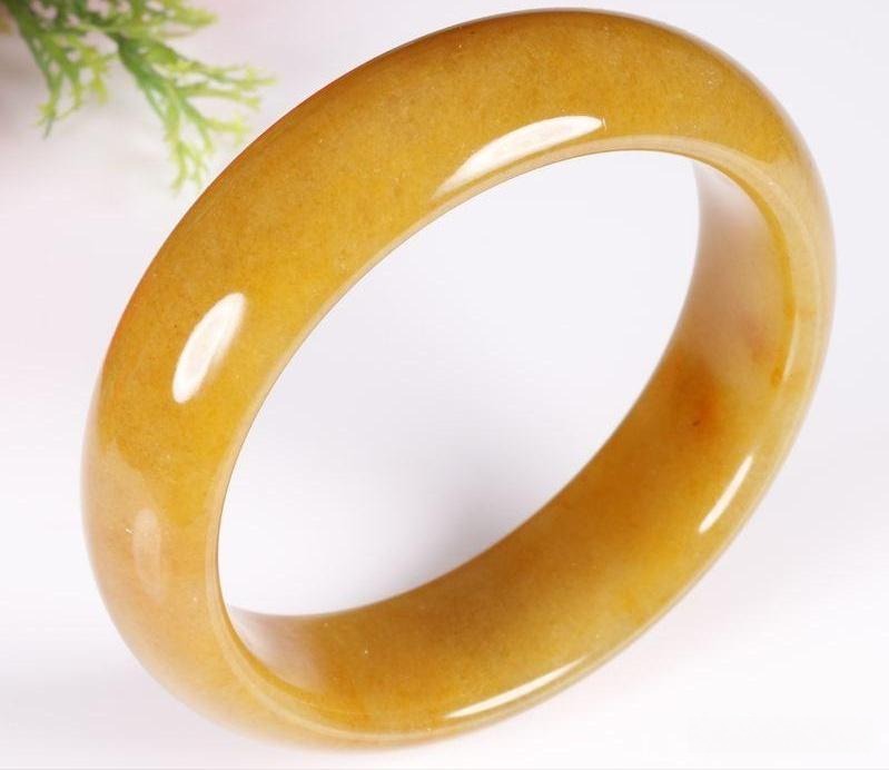A Jinsi Jade (quartzite) bangle featuring a brown-yellow color that closely resembles the desirable 'Sugar' variety of Hetian Nephrite Jade.