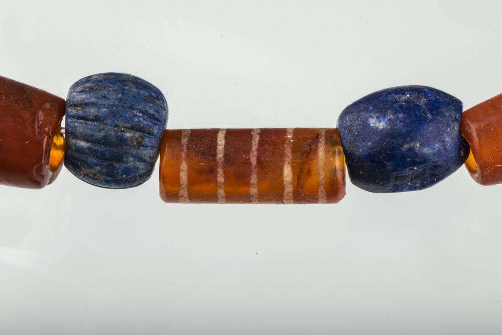 Lapis lazuli and carnelian jewelry with intricate patterns, creating a striking and meaningful design.