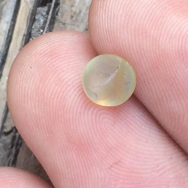 Natural cat’s eye gemstone with minor dark inclusions and slightly uneven base