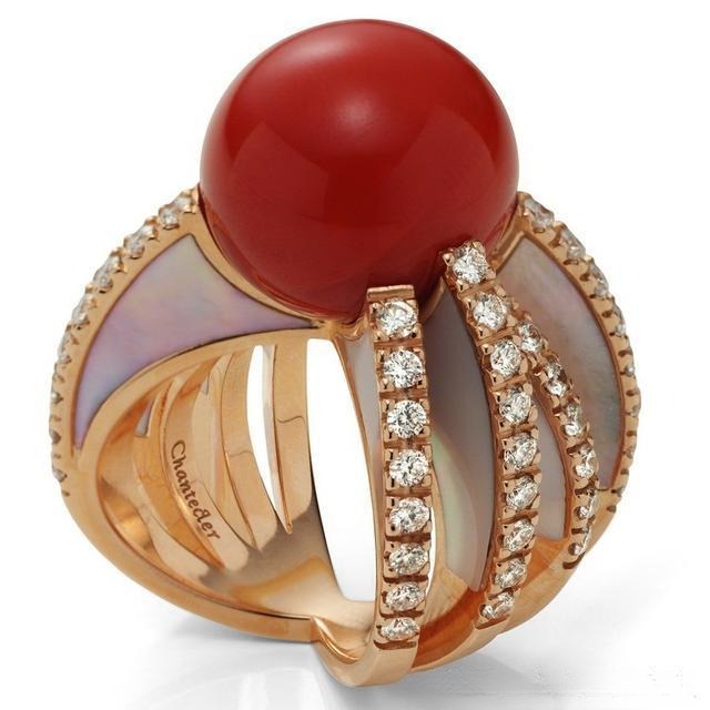 Handcrafted gold ring featuring a vibrant red coral gemstone
