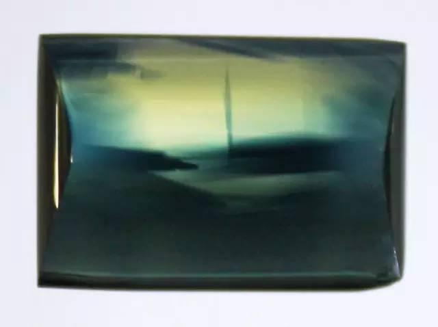 A square-cut Chang Le Sapphire showing the natural bi-color coexistence of both blue and yellow sapphire within the stone.