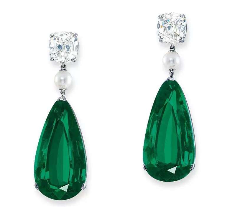 A pair of 23.34 and 23.18 carat Colombian emerald earrings, known as The Grand Muzos, with deep, uniform color and no oil treatment.