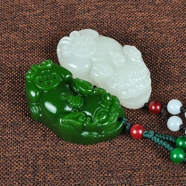 Ultrasonic-pressed jade pendant showing mass-produced design with rigid lines and uniform details.