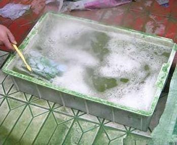 Low-quality jadeite stones soaking in strong acid baths as part of common gemstone treatments and enhancements.