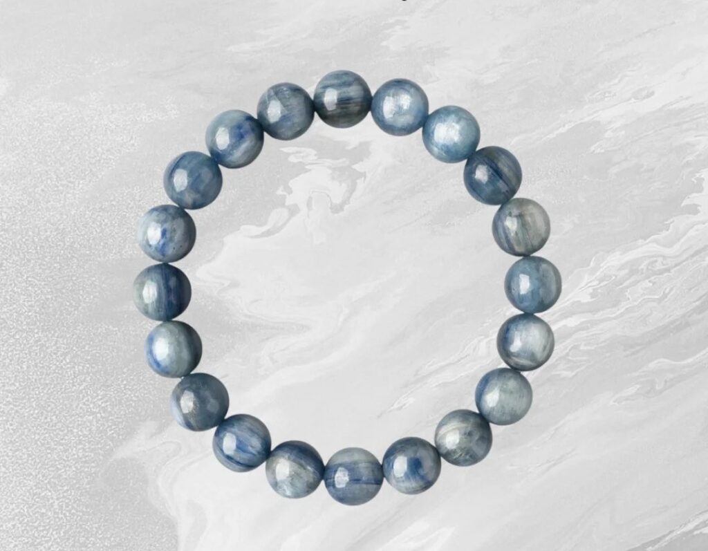 Entry-level blue gemstone bracelet featuring visible white banding and natural mineral striations.