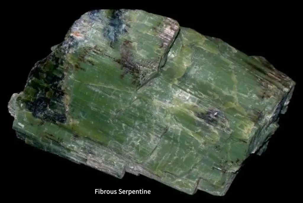 A raw sample of fibrous Serpentine, illustrating the characteristic structure of common Xiu Jade.