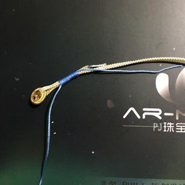 The finished hanging loop with excess threads trimmed, sealed, and the pearl flower ball gently pushed to conceal the wrapped section.