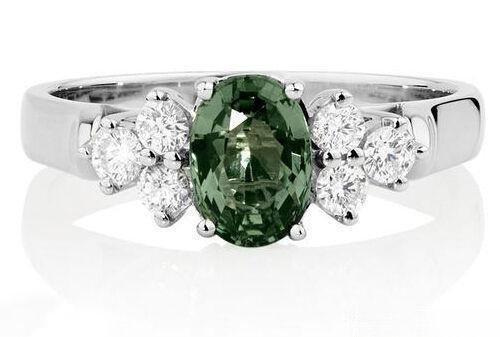 Ring featuring a large, brilliant green (fancy colored )sapphire center stone, accented by sparkling white diamonds.