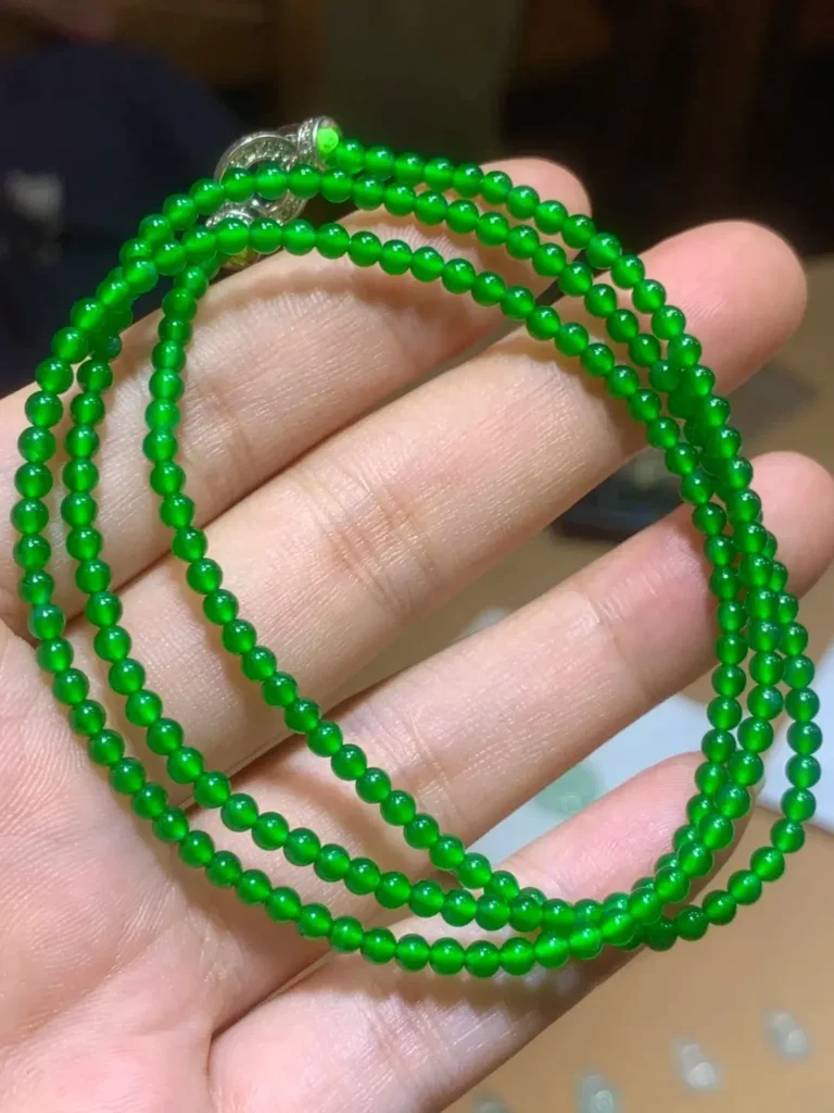High-quality Guatemalan jade beads showing cost comparison with Imperial Green jade.
