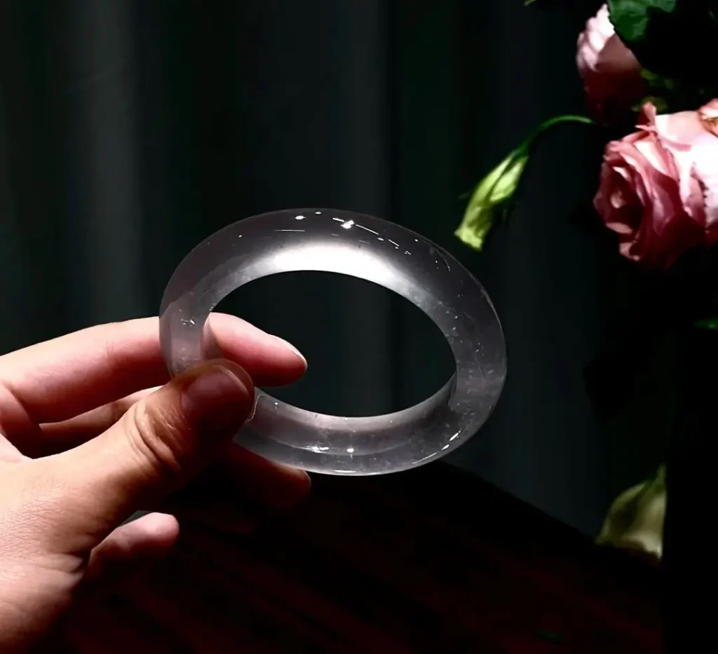 A magnificent high-icy Jadeite bangle exhibiting exceptional transparency and a luminous, ethereal glow.