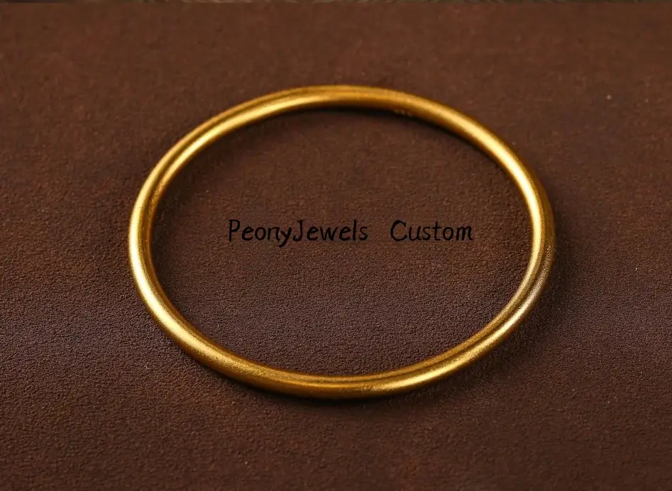 A 68.97g Jewea handmade custom 24K gold bangle demonstrating zero gold recasting weight loss.