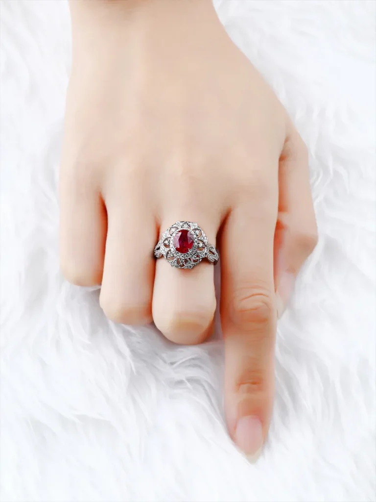 Model wearing a Jewea bespoke 18K gold ring with a natural unheated pigeon blood ruby and diamonds.