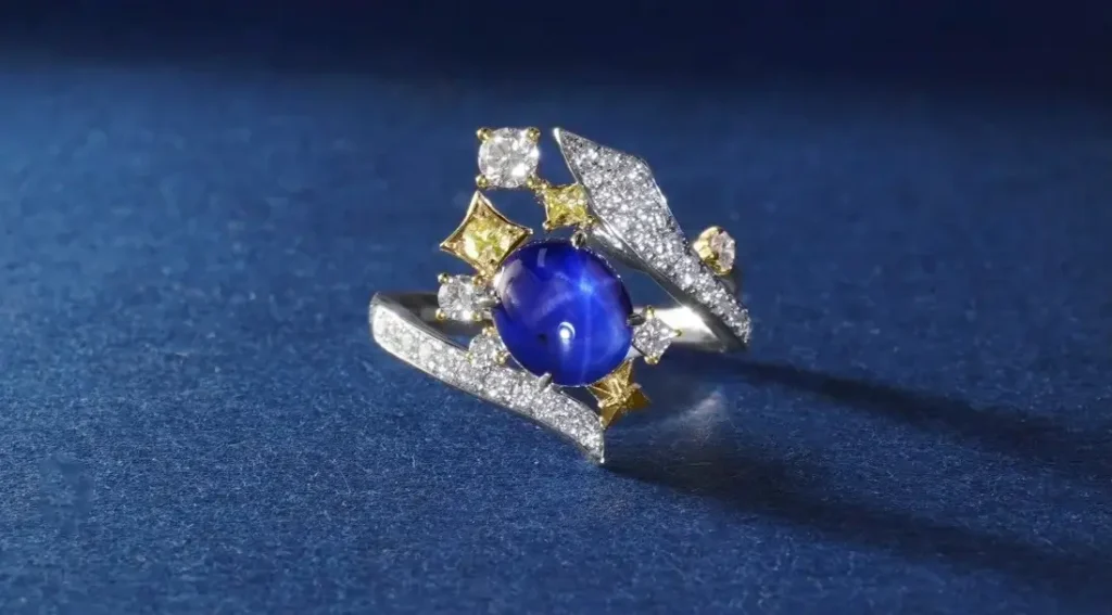A custom Jewea ring featuring a large, vibrant star(fancy colored) sapphire cabochon set in a modern, bespoke design.