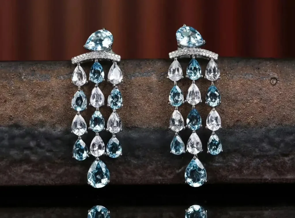 Pair of elegant Jewea earrings featuring clear, colorless white sapphires in a minimalist setting.