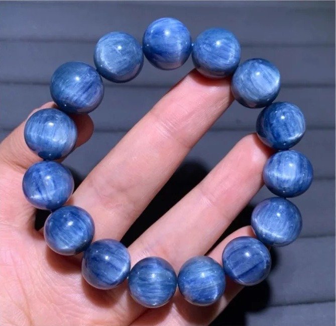Mid-grade blue gemstone bracelet with improved color uniformity and subtle light-reflecting cat-eye effects.
