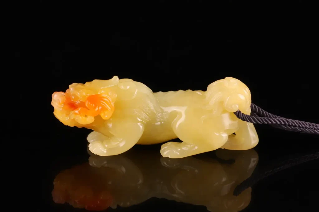 Hand-held Shoushan Furong stone carving with smooth waxy texture.