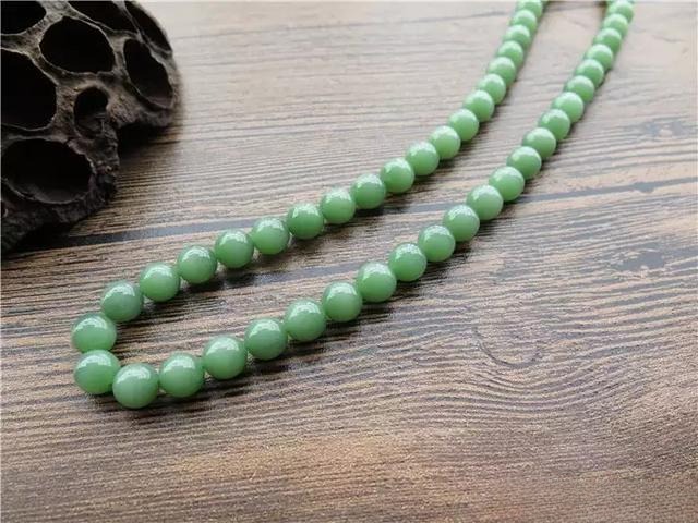 Jasper bead necklace shown in natural sunlight versus indoor lighting.