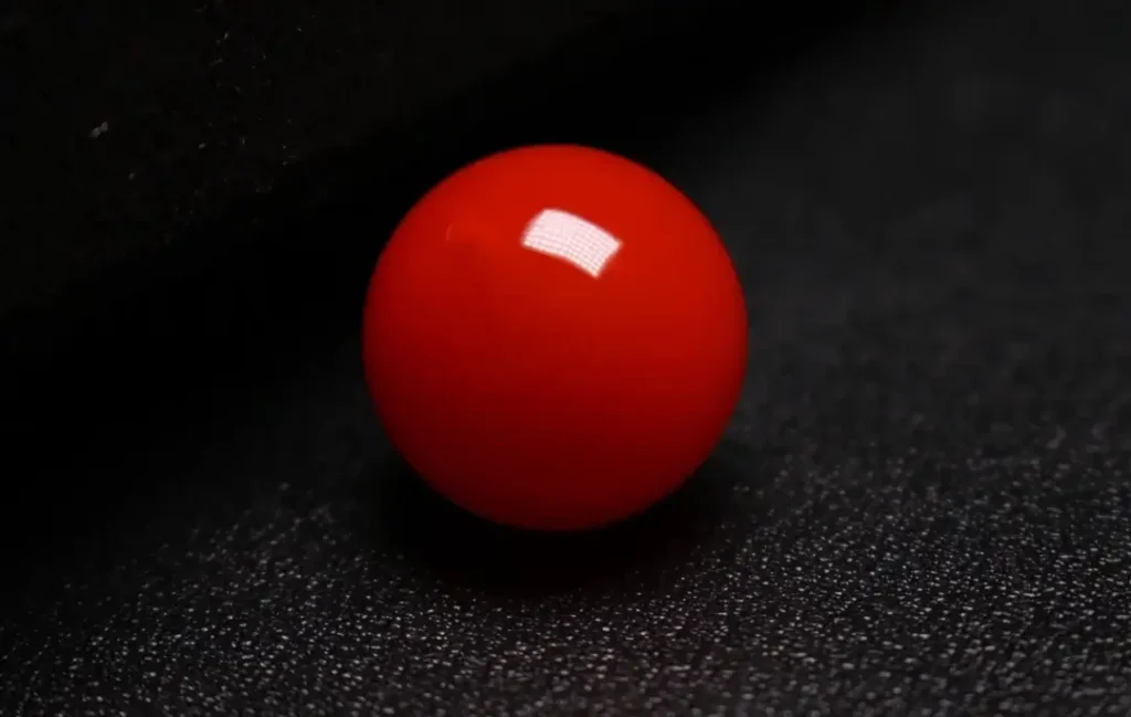 Close-up of a premium, saturated Jin Red Southern Red Agate stone showing uniform color.