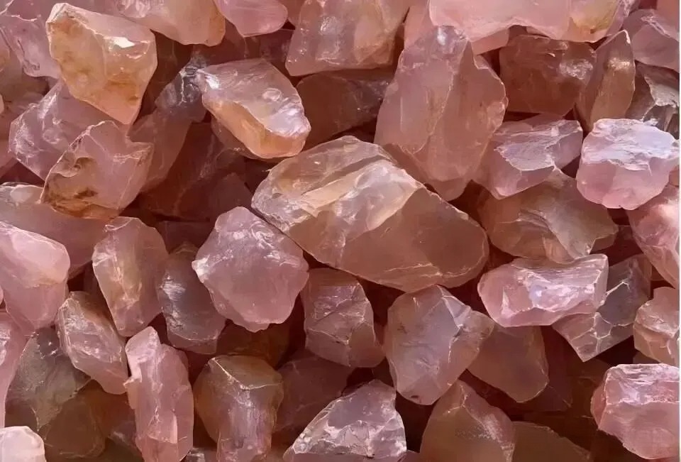 Raw pink rose quartz mineral specimen with soft translucency.