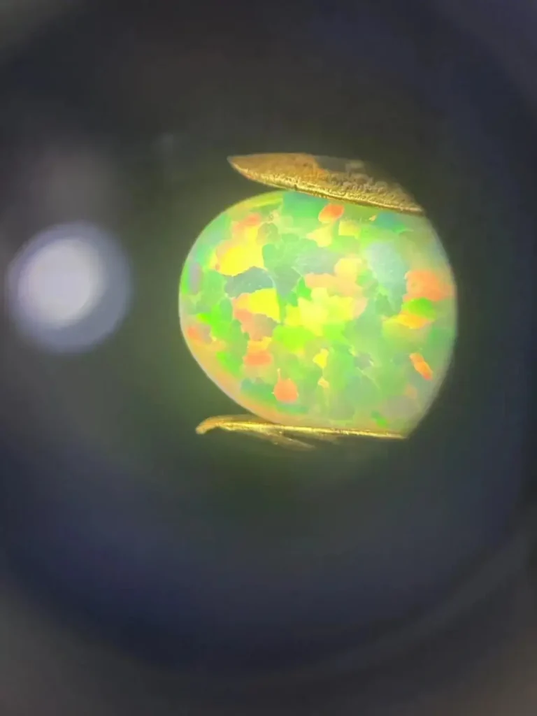 Microscopic image of synthetic opal showing the artificial "lizard skin" or honeycomb pattern.