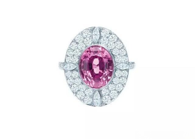Tiffany & Co. platinum ring featuring a vibrant pink sapphire center stone and diamond accents, highlighting the gem's romantic color.