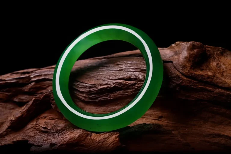 A stunning, high-value Icy or Glassy Jadeite bangle with excellent transparency and vibrant internal glow.