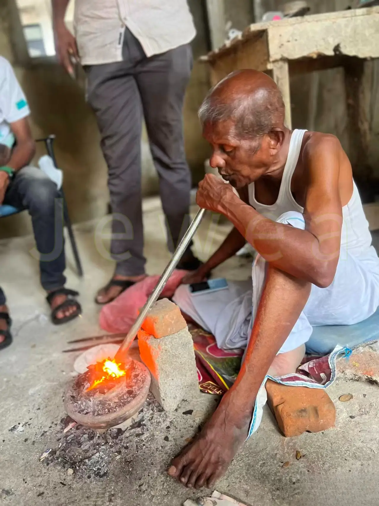 Early Sri Lankan miners using blowpipes and charcoal fires to heat raw rubies.