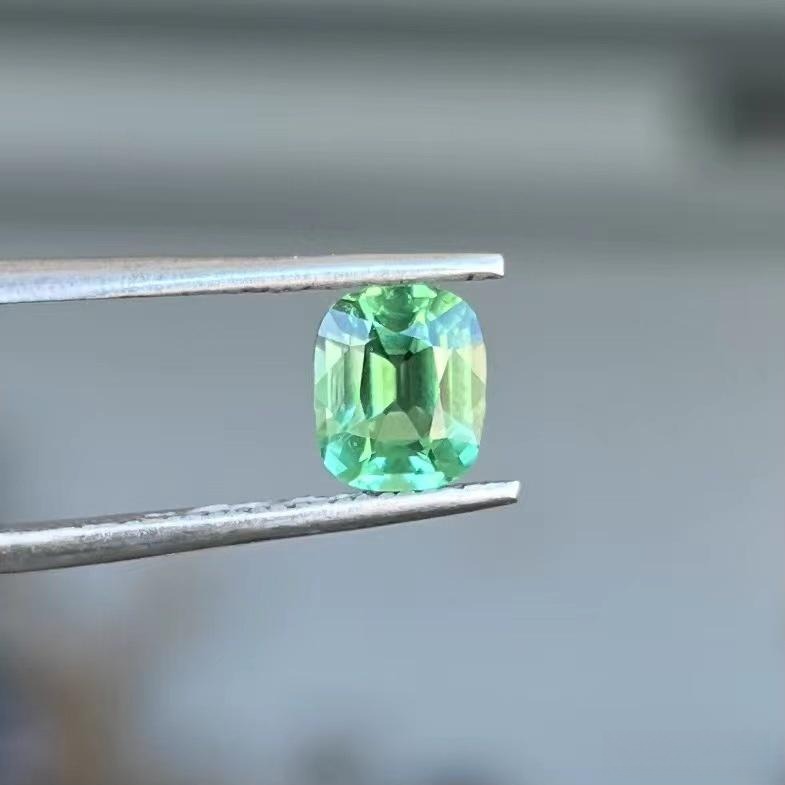An eye-clean 1.48ct cushion-cut Afghan tourmaline with vivid color saturation and high clarity.