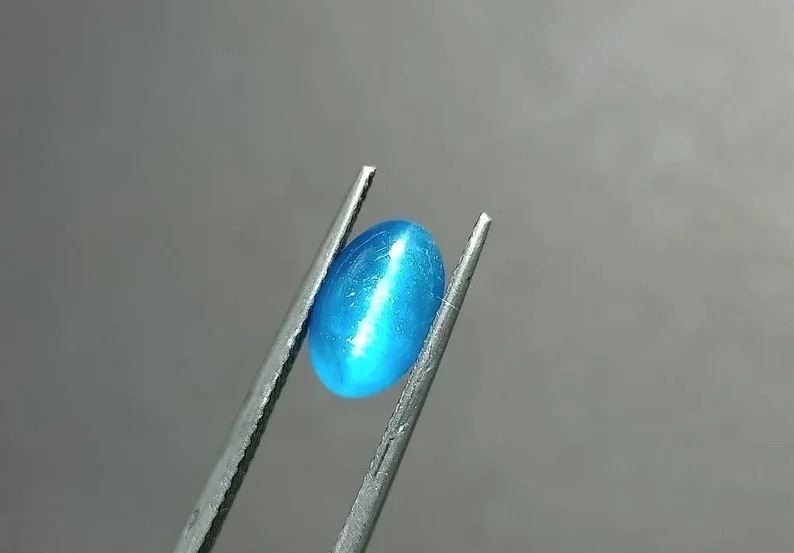 2.32-carat blue cat’s eye apatite displaying vivid neon blue color and strong chatoyancy, highly collectible.