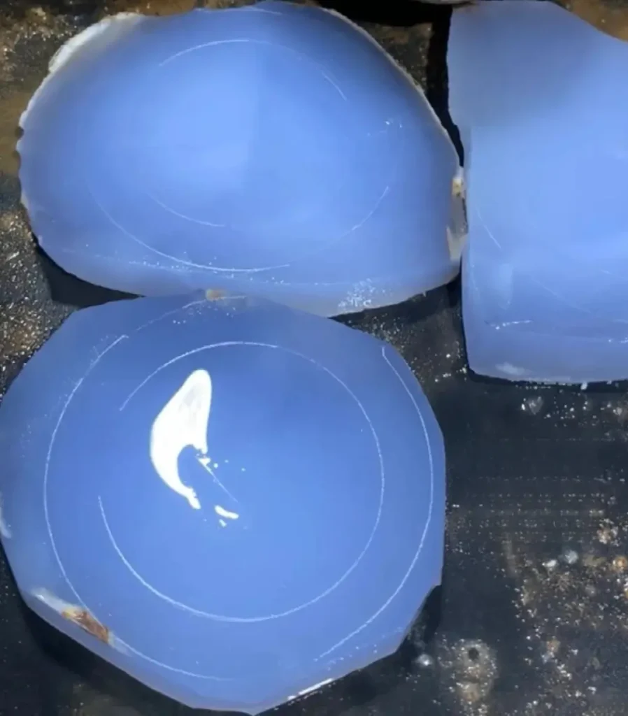 Sliced blue chalcedony showing semi-translucent cryptocrystalline structure and natural blue hues.