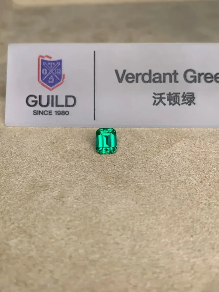 Faceted Brazilian emerald displaying intense Verde Verdant green with minor oil treatment.