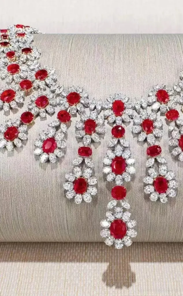 A luxury necklace featuring vivid red Burmese rubies surrounded by brilliant white diamonds.
