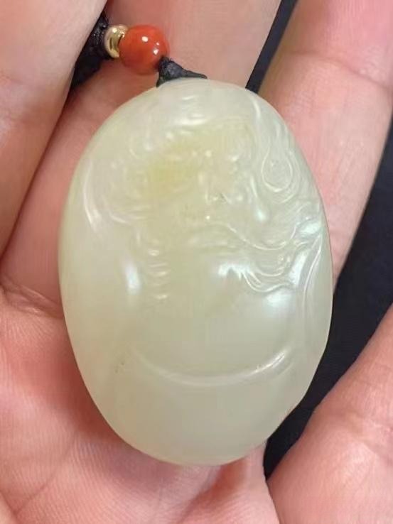 Faded Qiemo sugar-white Guan Gong pendant returned by client.