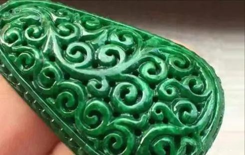 Opaque, vivid dark green jadeite slab with a dry, coarse surface and no light transparency.