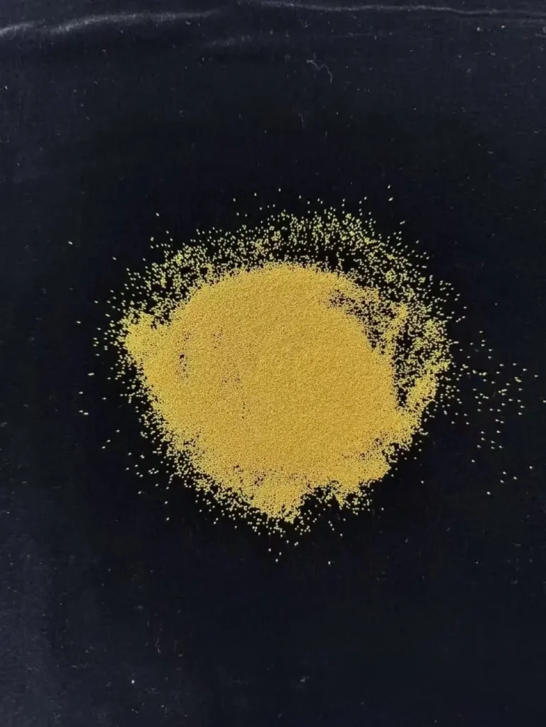 Tiny gold beads, no larger than 1mm, resembling millet grains, used in granulation jewelry.