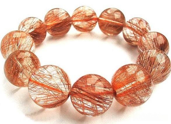 Gold Rutilated Quartz bracelet with needle-like rutile inclusions suspended inside clear quartz.