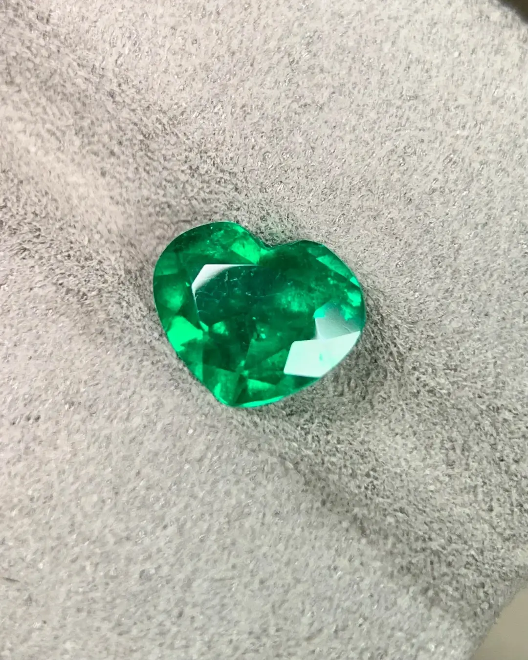 Natural 1.25-carat heart-cut Colombian emerald with GRS-certified Muzo Green color and high saturation.