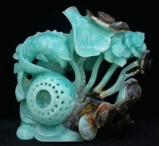 A Gui Jade fish and lotus carving from Guizhou, China, featuring emerald-green quartzite textures.